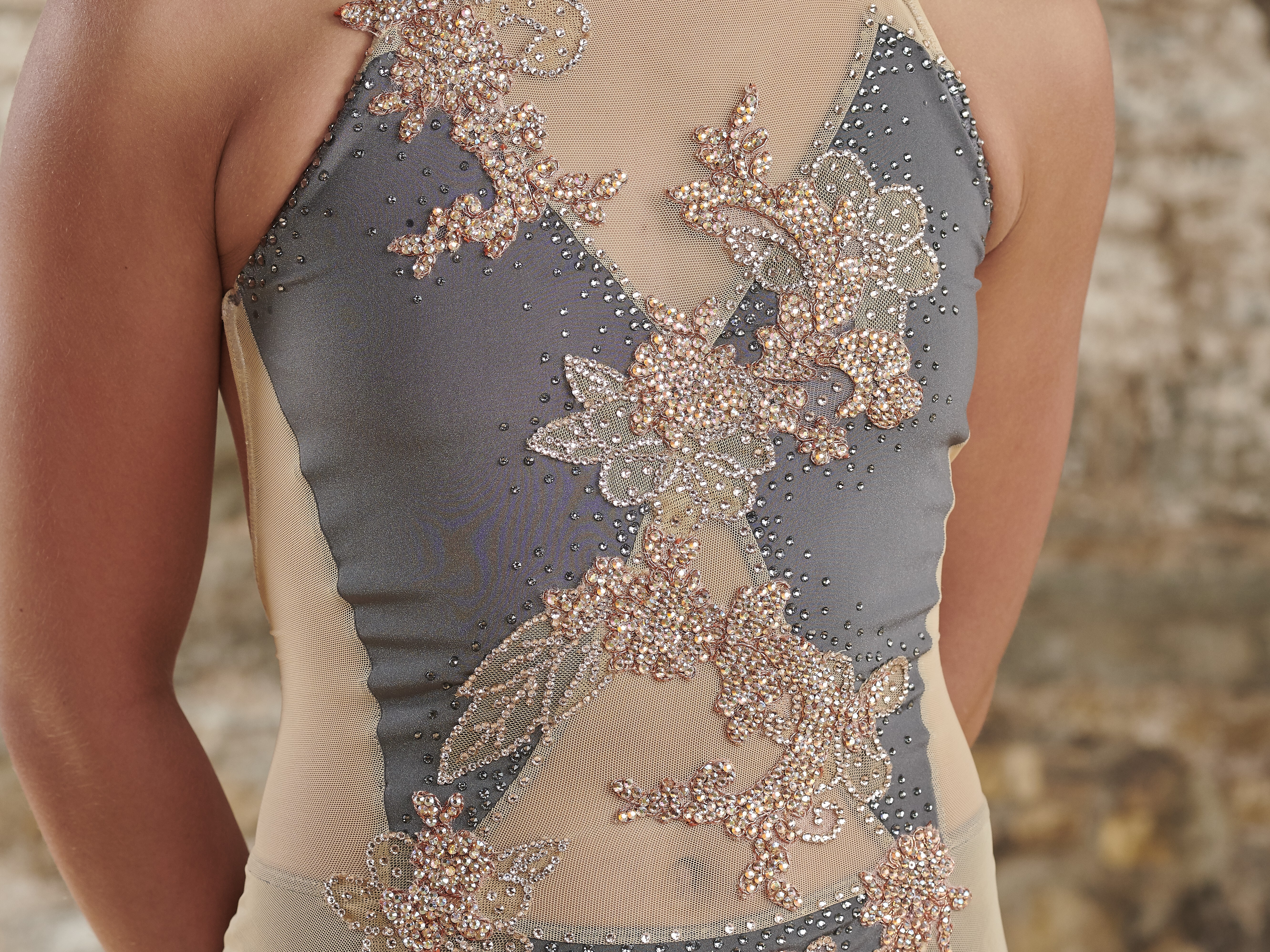 Rose gold crystal floral appliqué detail on a mesh dance costume bodice