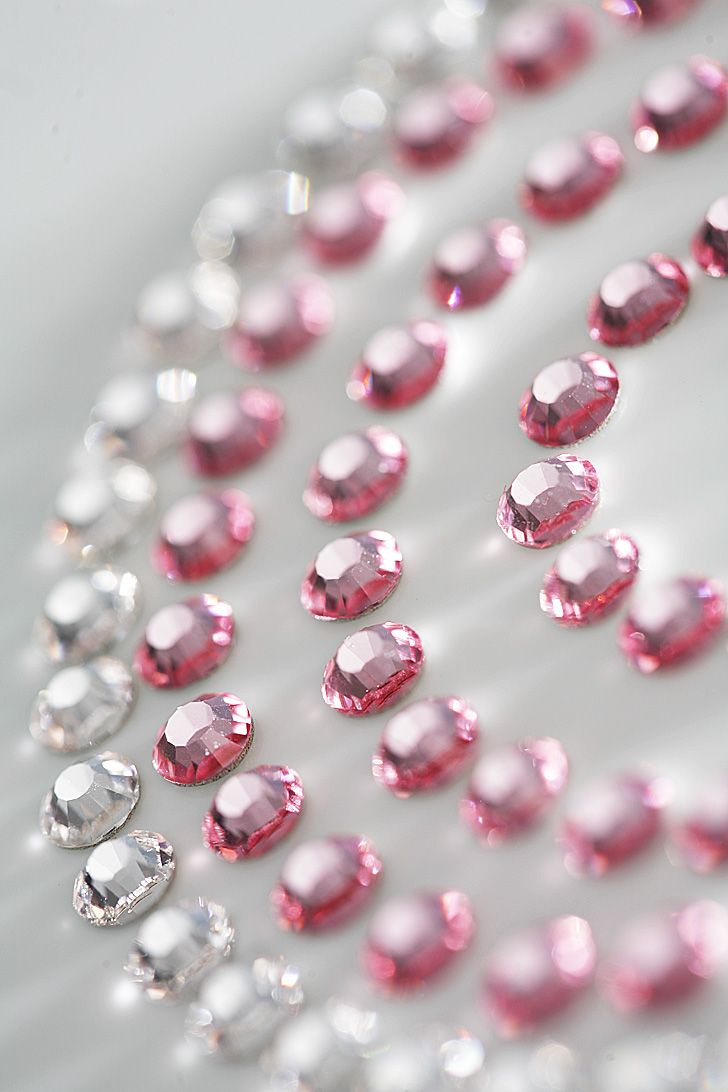 Pink and clear rhinestones in concentric circles. Images focuses on the bottom left of the pattern.